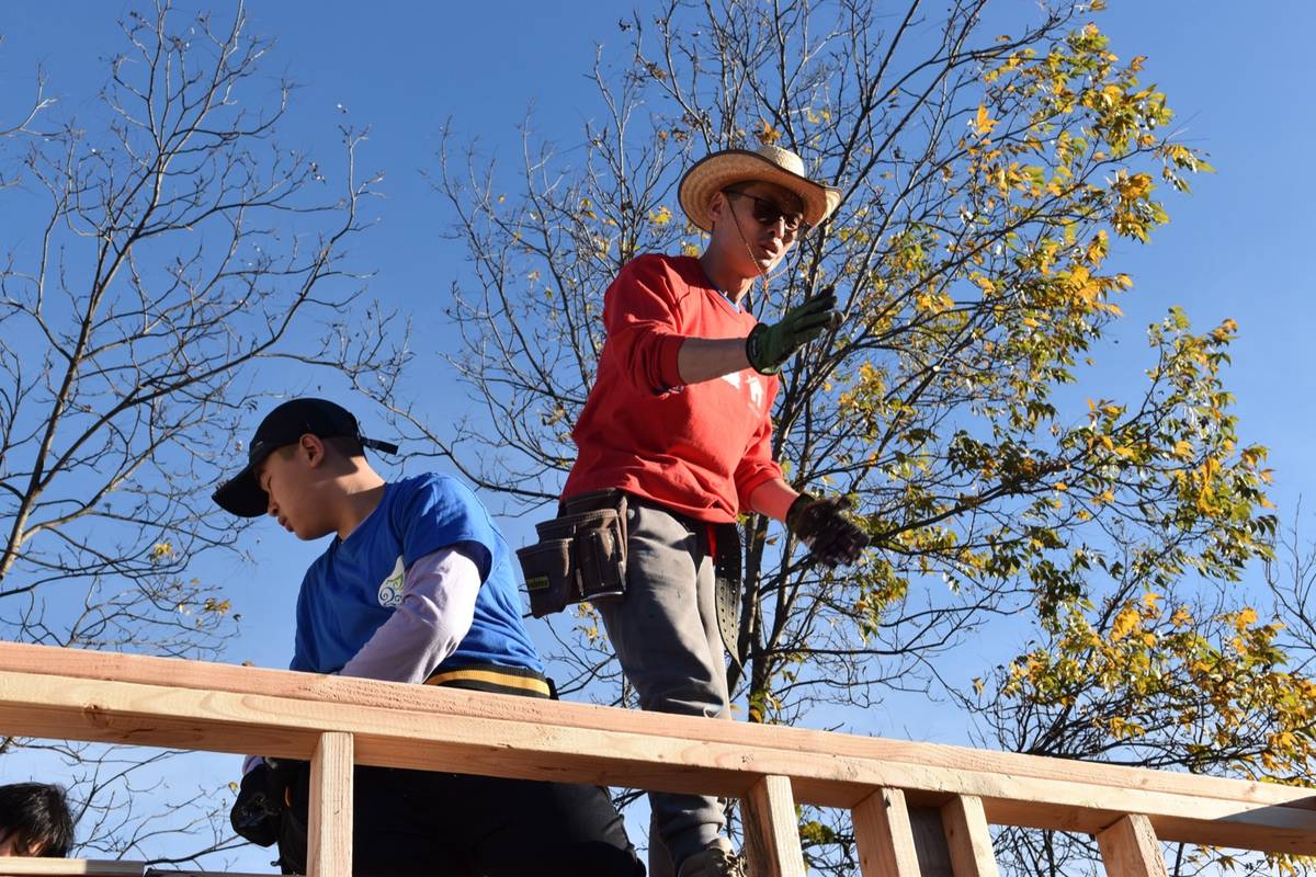 A framing crew at work in golden morning light