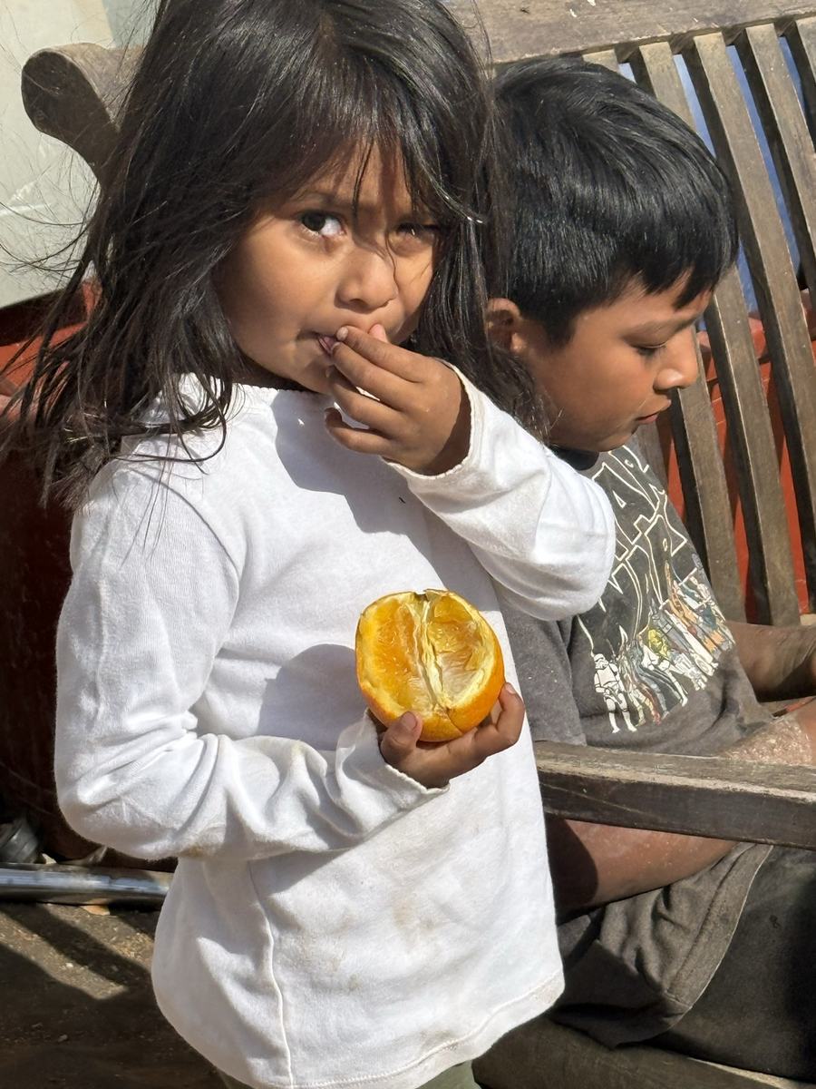 Kids sharing fruit on the build site