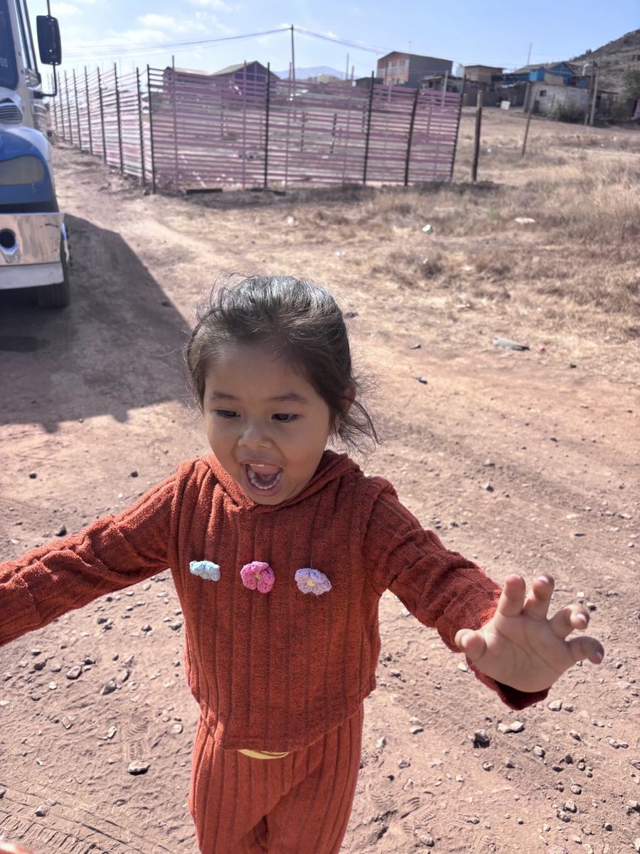 A joyful toddler reaching toward the camera