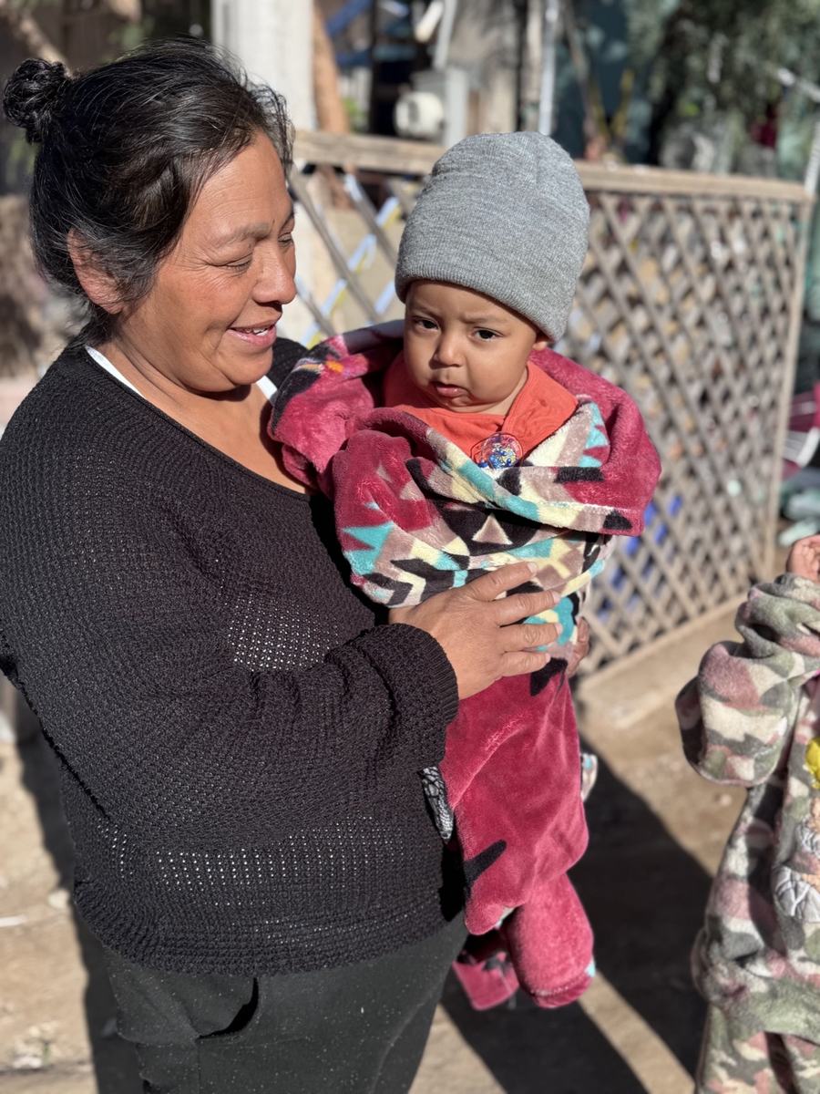 A grandmother holding her grandchild