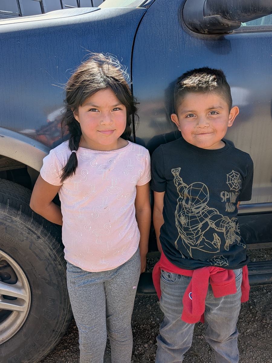 A brother and sister standing together
