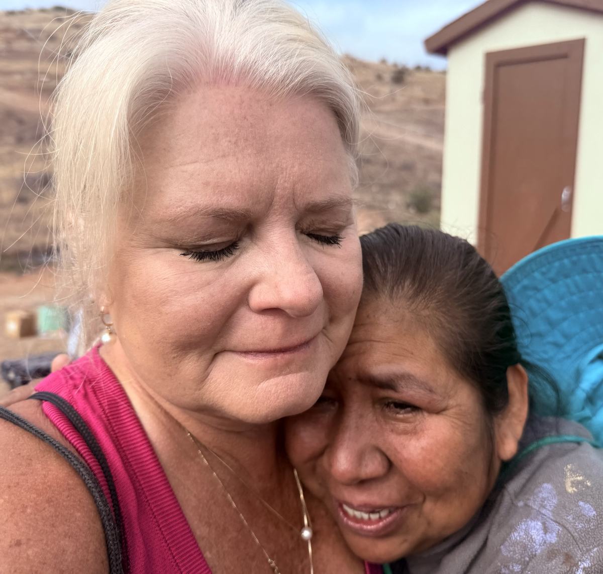 A volunteer and a Tecate mother embracing at a home dedication