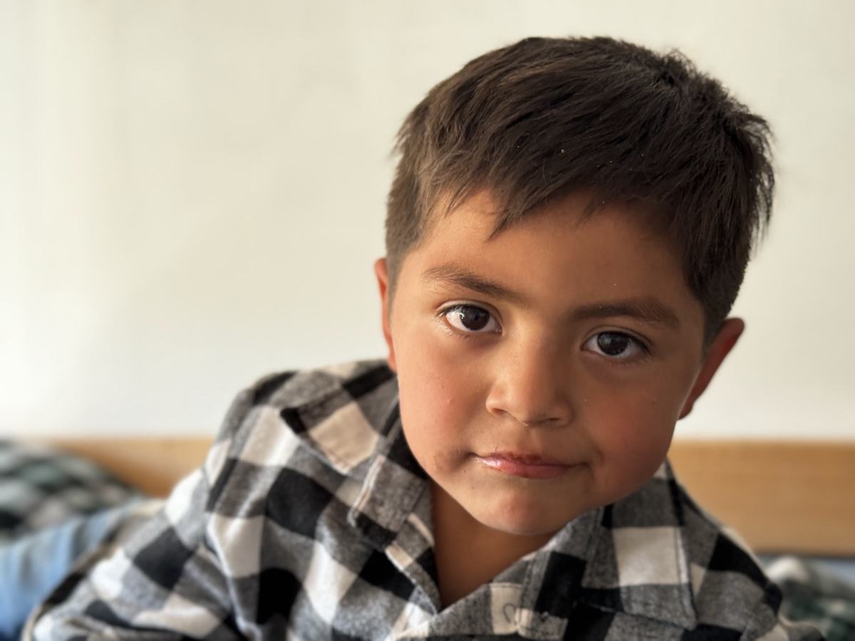 A young boy in a plaid shirt