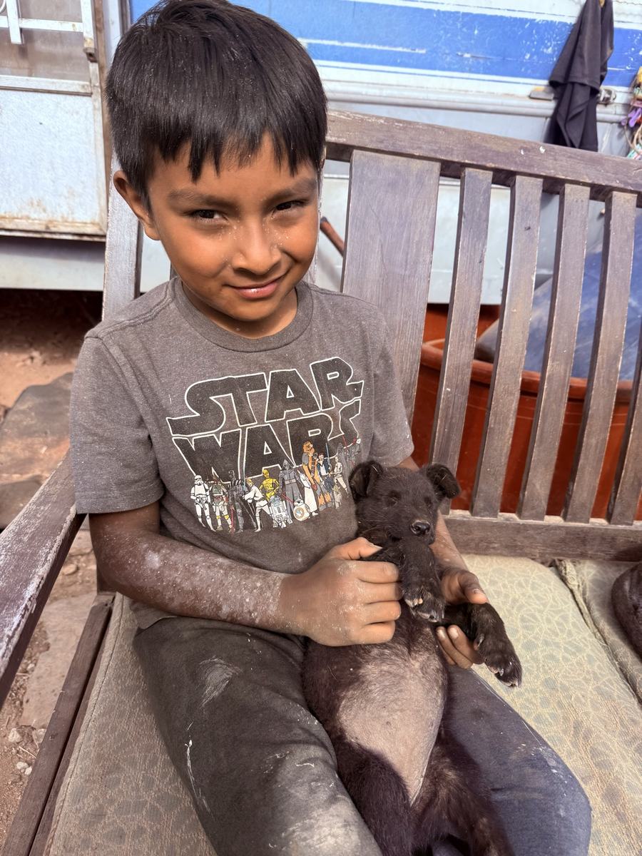 A boy holding his puppy