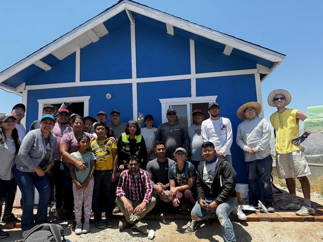 The whole crew at a finished blue home