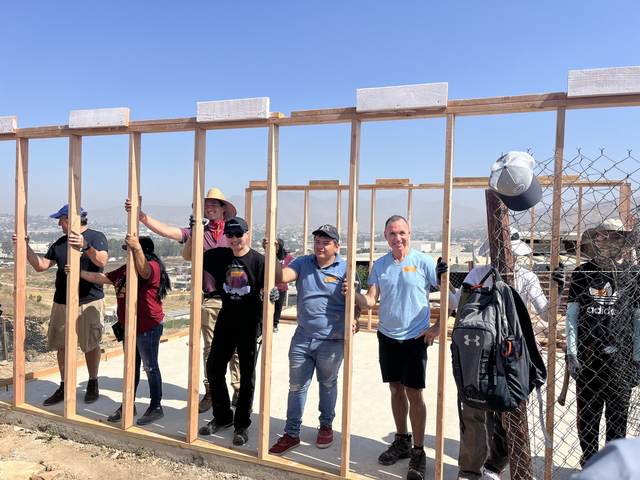 The crew at a freshly framed wall