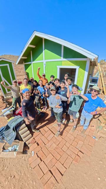 Kids giving thumbs up at a green home