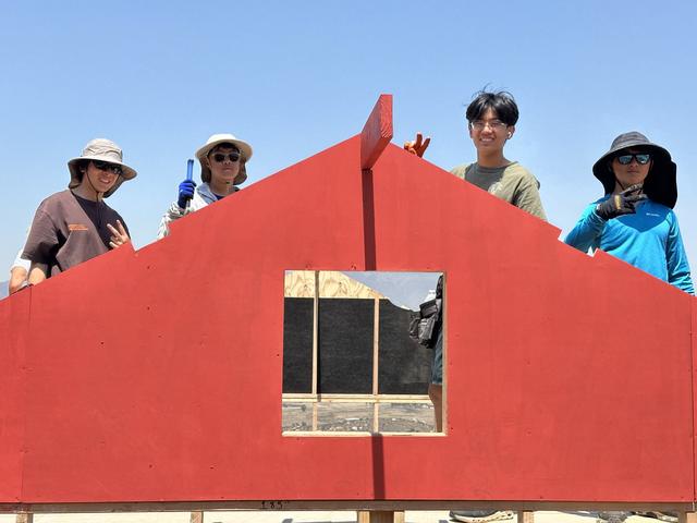 A painted gable wall being raised
