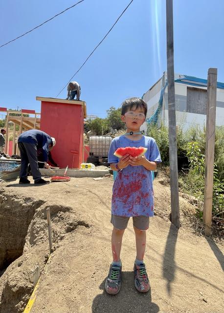 A boy enjoying watermelon on the site