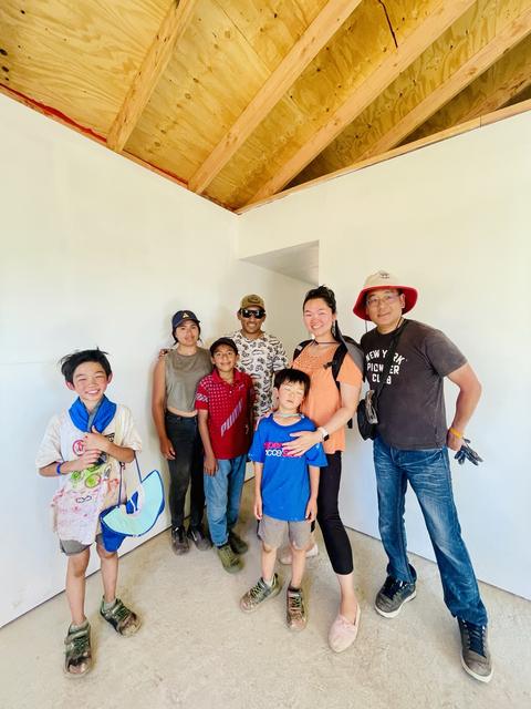 A family and volunteers inside their finished home