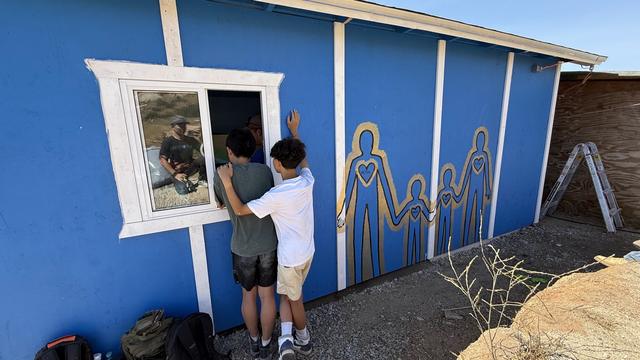 Kids painting a family mural