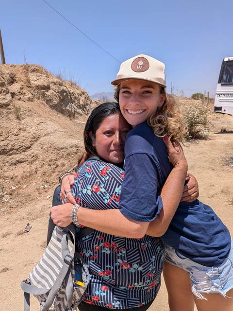 Two volunteers hugging on the build site